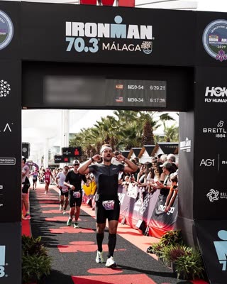 João walking under the finish arch at Ironman 70.3 Málaga